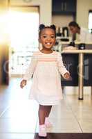 Strutting my stuff. Full length portrait of an adorable little girl walking through her home.