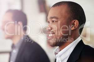 Confidence is key. Cropped shot of two businessmen looking in the same direction while seated outside.