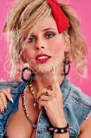 Everyone looked like a rockstar in the 80s. Studio shot of a beautiful young woman wearing a 80s outfit.