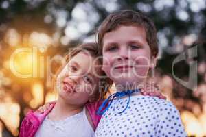 Nothing beats having a big brother. Shot of a little boy and his sister standing outside.