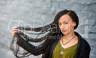 Beautifully twisted braids. Portrait of an attractive young woman with beautiful braids posing outdoors.