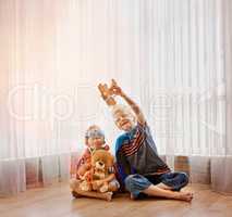 He knows just how to entertain his little brother. Shot of two little boys playing together at home.