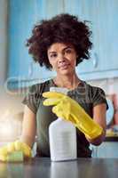 My job is never done. Cropped shot of an attractive young woman with yellow gloves cleaning her home.