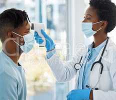 Lets take your temperature. Shot of a female doctor taking the temperature of her patient.