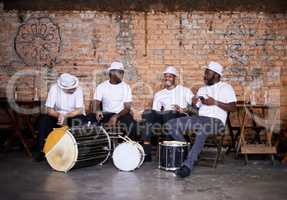 Playing to the Brazilian beat. Shot of a band playing their percussion instruments in a Brazilian setting.