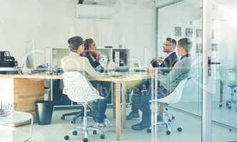 They're a team of planners. Shot of a group of corporate colleagues sitting in the boardroom during a meeting.