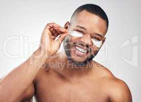 Providing next-level hydration to his skin. Studio portrait of a handsome young man wearing under-eye patches against a white background.