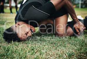 What a bad mishap. Cropped shot of a handsome young rugby player suffering with an injury on the field.