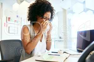 I should've taken off sick. Shot of a businesswoman working at her desk.