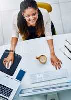 Onwards and upwards. High angle portrait of an attractive young businesswoman working at her desk in the office.