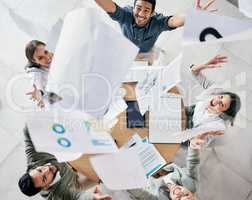 One positive thought can change your whole day. Aerial shot of a diverse group of businesspeople throwing paperwork in the air in celebration while in the office.