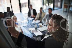 We can go step by step. High angle shot of a young businesswoman explaining work related stuff during a presentation to work colleagues in a boardroom.