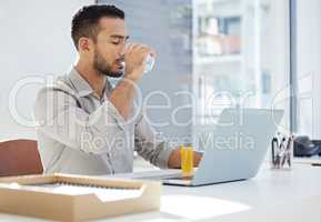 The energy levels are high. Shot of a young man using his laptop and having coffee at work in a modern office.