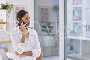 Never called for fame, no fighting in your name. Shot of a businesswoman on a phone call in a modern office.