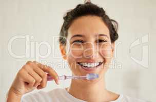 No one ever regrets taking good care of their teeth. Shot of a young woman brushing her teeth.