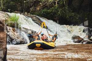 Go where you feel most alive. Shot of a group of friends out river rafting on a sunny day.