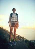 It thrills me to be out in search of adventure. Portrait of a young woman out on a hike through the mountains.