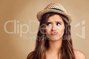 You dont have to be weird about it. Studio shot of a beautiful young woman looking thoughtful against a brown background.