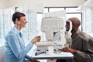 Eye care that's clearly the best. Shot of an optometrist examining her patients eyes with an autorefractor.