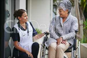 Long term support for for the senior years. Shot of a senior woman in a wheelchair being for for by a nurse at a retirement home.