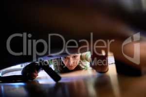 She never misses a spot. Shot of a young woman vacuuming underneath a piece of furniture.