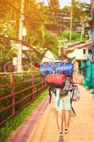 Seeing the city on foot. Rearview shot of a young backpacker exploring a foreign city on his own.