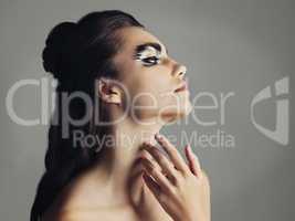 Keep it appealing to the eye. Studio shot of an attractive young woman wearing bold eye makeup.