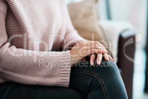 Patience is the path to peace. Cropped shot of a woman sitting on a sofa at home.