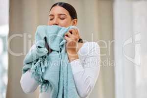 This smell should be bottled. Shot of a young woman smelling freshly cleaned laundry.