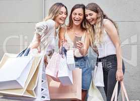 Check this out. Cropped shot of three attractive young women taking some time out to enjoy a shopping spree in the city.