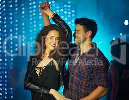 Dancing to the rhythm of love. Shot of an affectionate young couple dancing together in a nightclub.