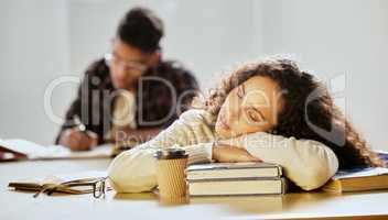 Studying can be exhausting. Cropped shot of an attractive young female college student sleeping on her textbooks in class.