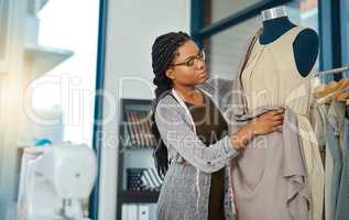 Believe in yourself and be prepared to work hard. Shot of a young woman working in her clothing boutique.