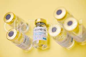 This vaccine is a real game changer. Studio shot of vaccine tubes against a yellow background.