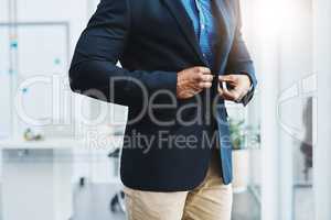 Take pride in your appearance. Closeup shot of an unrecognizable businessman fastening a button on his blazer in an office.
