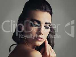 I like to be a little different. Studio shot of an attractive young woman wearing bold eye makeup.