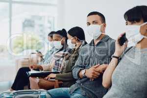 Never underestimate the importance of patience. Shot of a group of young people wearing masks in a waiting room.