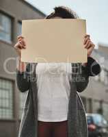 Put yourself out there. Cropped shot of an unrecognizable woman holding a sign while protesting for her rights.