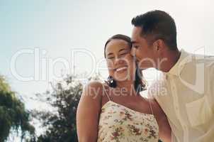 I love her endlessly. Shot of a happy young couple standing outside together and sharing a romantic moment.