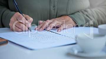 Prepare for the unexpected. Shot of an unrecognizable businessperson going through paperwork at work.