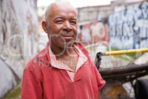 Content despite his hardships. Portrait of a garbage picker in the streets of Brazil.