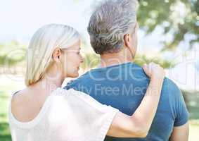 Supportive and loving. Rear-view of a mature couple looking away while standing outdoors.