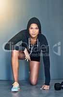 The word cant doesnt exist in my vocabulary. Shot of a fit young woman doing lunge squats during her workout.