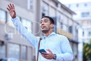 I need you to take me downtown. Shot of a young businessman hailing a cab.