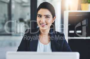 Put in the work, reap the rewards. Cropped shot of an attractive young businesswoman in her office.