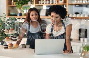 Will you be able to work this shift next week. Shot of two young women working together on a laptop in a cafe.