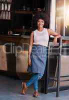 Hold on to your entrepreneurial spirit. Portrait of a confident young business owner posing in the doorway of her coffee shop.