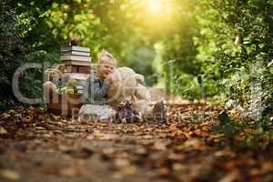 Allow them to think more freely. Shot of a little girl reading to her toys while out in the woods.