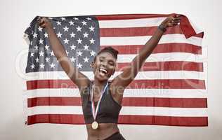 You can congratulate me now. Shot of a young female athlete celebrating her win while running with a flag.