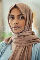 The Muslim Women is Clothed in strength Dignity. Shot of a young muslim woman sitting in the loung at home.